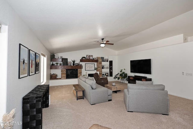 carpeted living room with a glass covered fireplace, baseboards, a ceiling fan, and lofted ceiling