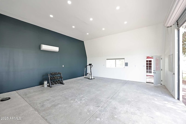 interior space with recessed lighting, a wealth of natural light, and a wall mounted air conditioner