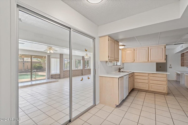 kitchen with white dishwasher, light tile patterned flooring, ceiling fan, and light brown cabinets