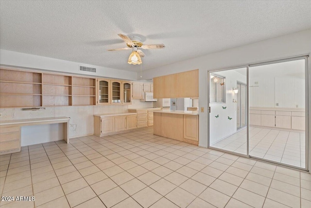 kitchen featuring a textured ceiling, ceiling fan, light brown cabinetry, light tile patterned floors, and white appliances