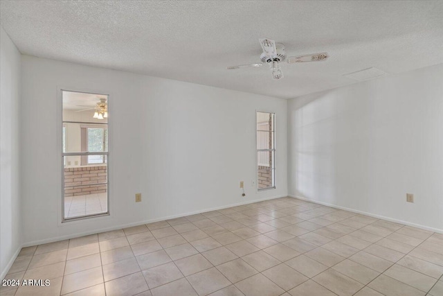 empty room featuring a textured ceiling and ceiling fan