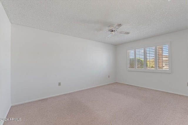 carpeted empty room featuring a textured ceiling and ceiling fan