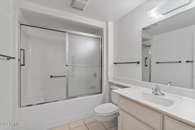 full bathroom with toilet, vanity, combined bath / shower with glass door, and tile patterned flooring