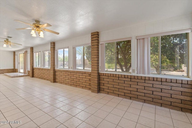 interior space featuring ceiling fan and plenty of natural light