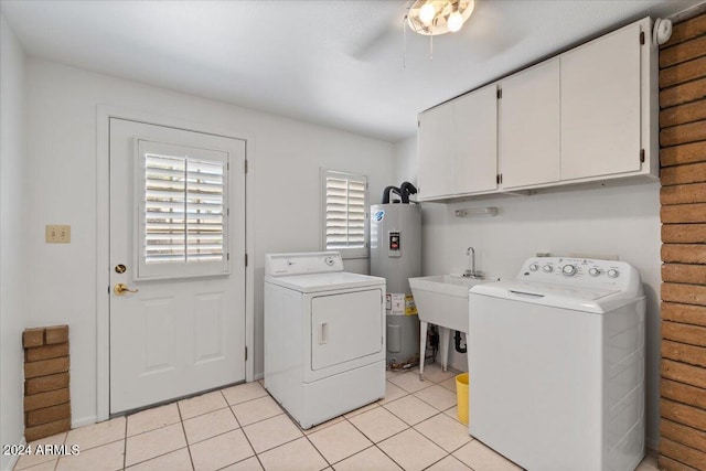 laundry room with light tile patterned flooring, sink, cabinets, independent washer and dryer, and electric water heater