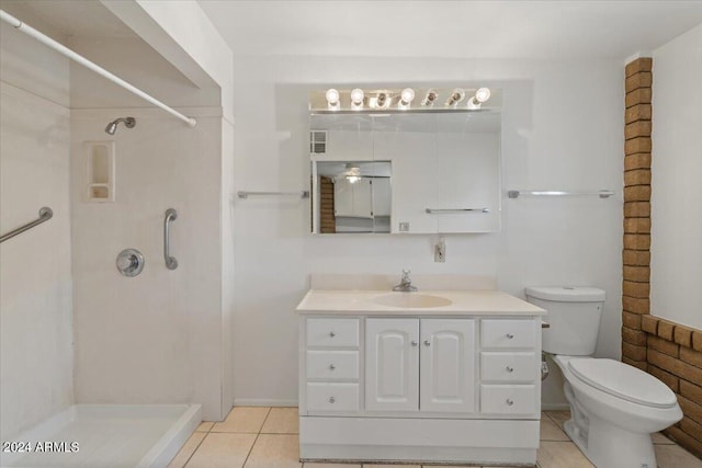 bathroom featuring vanity, toilet, tile patterned flooring, and a shower