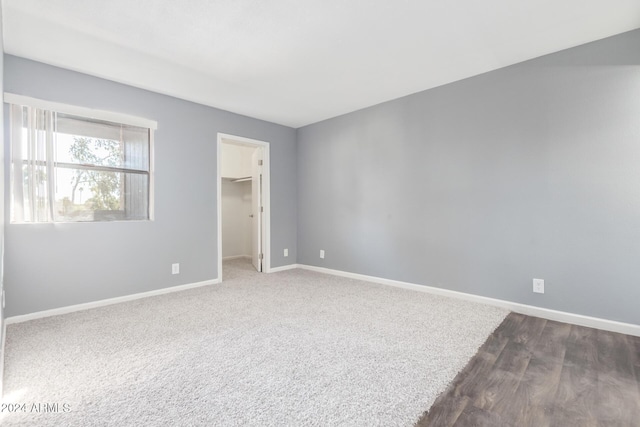 unfurnished room with dark hardwood / wood-style flooring