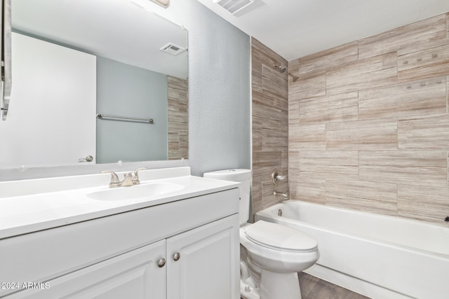 full bathroom with toilet, vanity, tiled shower / bath combo, and hardwood / wood-style flooring