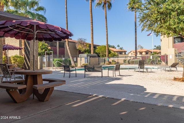 surrounding community with a patio and a swimming pool