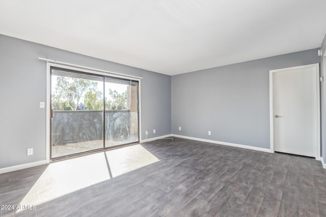 spare room featuring dark wood-type flooring