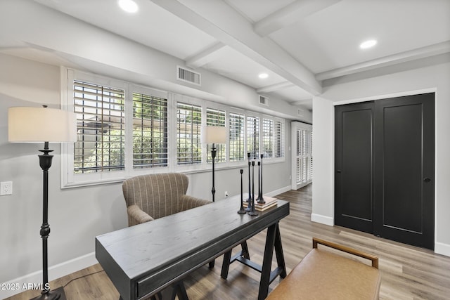 home office with beamed ceiling and light hardwood / wood-style floors