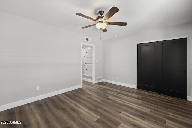 unfurnished bedroom with dark hardwood / wood-style flooring and ceiling fan