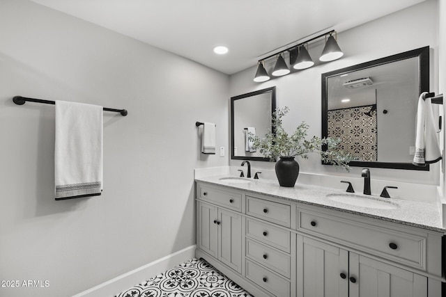 bathroom featuring tile patterned flooring, vanity, and walk in shower