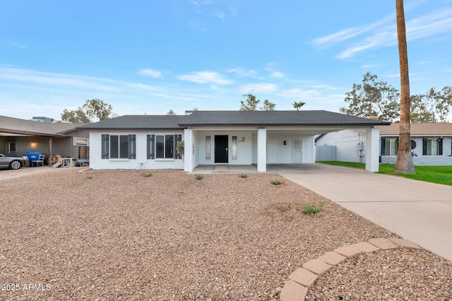 single story home with a porch and a carport