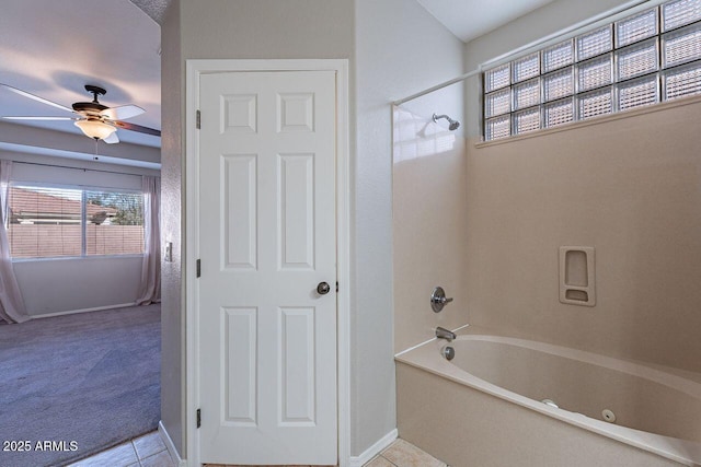 bathroom featuring ceiling fan, tile patterned floors, and shower / washtub combination