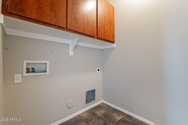 laundry room with hookup for an electric dryer, dark tile patterned flooring, hookup for a washing machine, cabinets, and gas dryer hookup