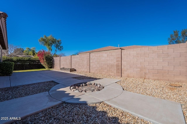 view of yard with an outdoor fire pit and a patio area