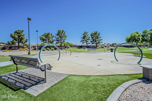 view of home's community featuring a playground and a yard