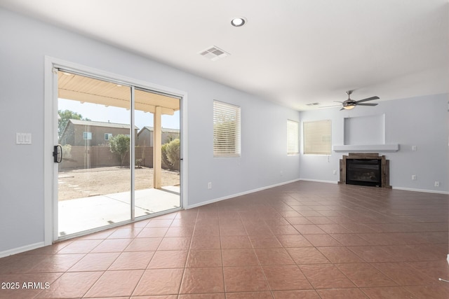 unfurnished living room featuring ceiling fan and tile patterned floors