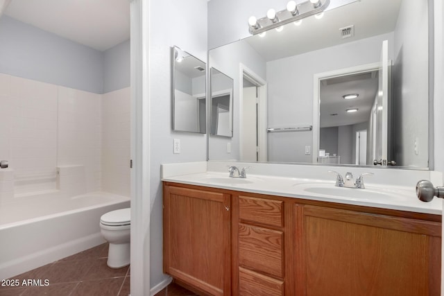 full bathroom with vanity, tile patterned floors, toilet, and washtub / shower combination