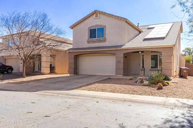 view of front of property with a garage, covered porch, and solar panels