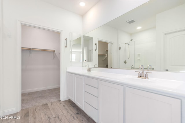 bathroom featuring vanity, an enclosed shower, and hardwood / wood-style flooring