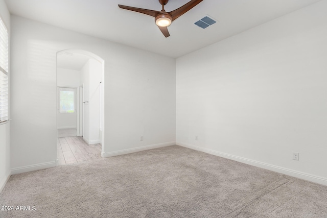 empty room with light carpet and ceiling fan