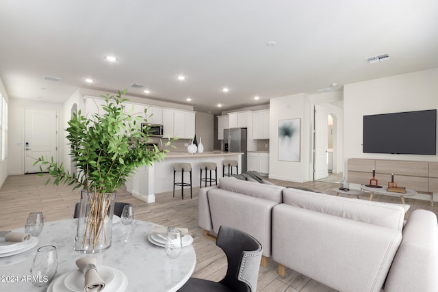 dining space with light hardwood / wood-style floors