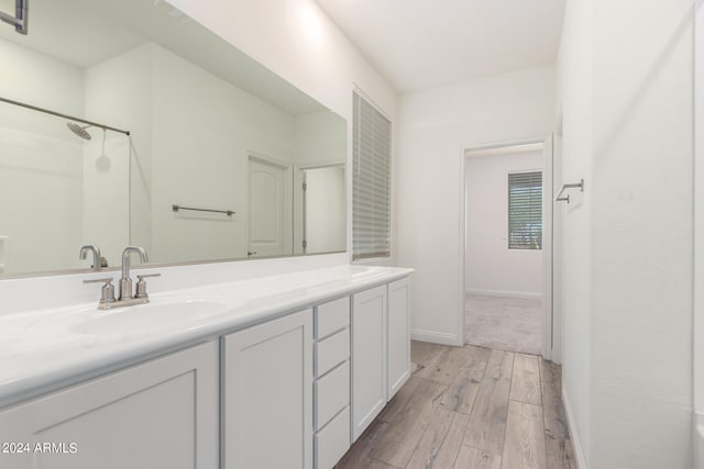 bathroom with vanity and hardwood / wood-style flooring