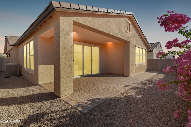 rear view of property featuring a patio and central AC unit