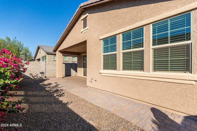 view of side of home featuring a patio area