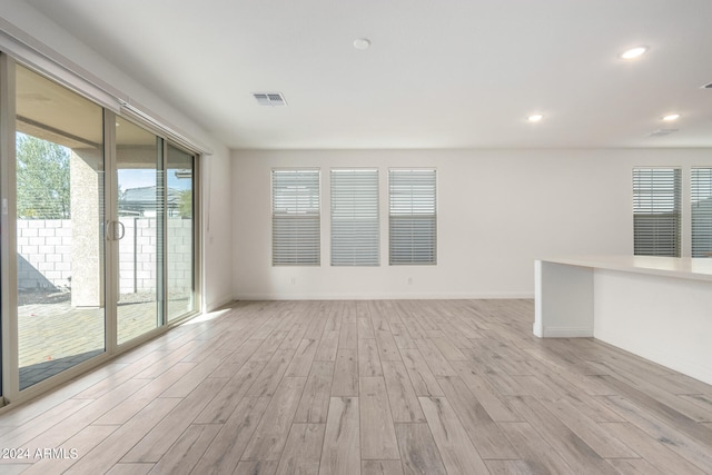 empty room with light hardwood / wood-style flooring