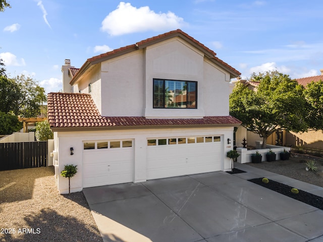 mediterranean / spanish home with driveway, a garage, a tiled roof, fence, and stucco siding