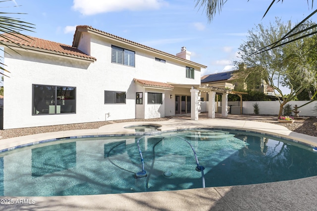 view of swimming pool with a patio area, a fenced backyard, a pool with connected hot tub, and a pergola