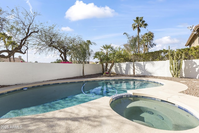 view of swimming pool with a pool with connected hot tub and a fenced backyard