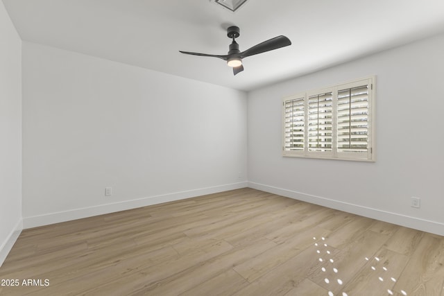 empty room with a ceiling fan, baseboards, and wood finished floors