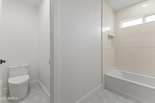 bathroom featuring tile patterned flooring, toilet, and baseboards