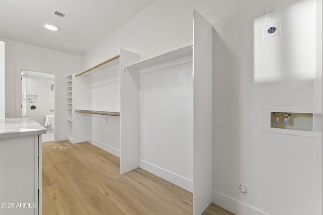 walk in closet featuring visible vents and light wood-style floors