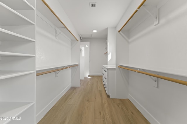 walk in closet with visible vents and light wood-style flooring