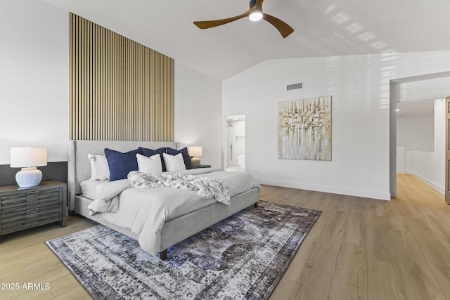 bedroom featuring baseboards, visible vents, a ceiling fan, wood finished floors, and vaulted ceiling