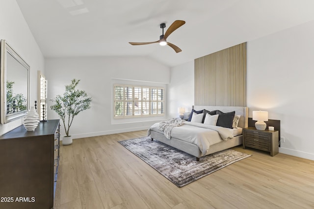 bedroom featuring lofted ceiling, a ceiling fan, light wood-style flooring, and baseboards