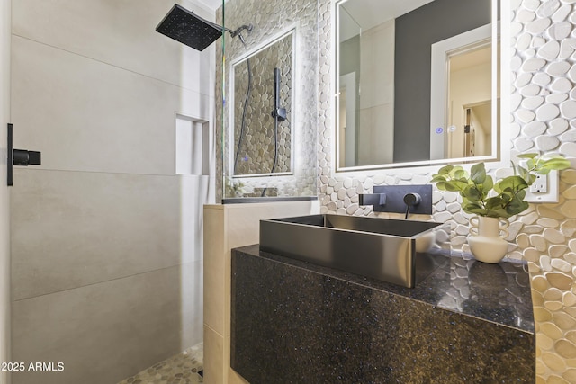 bathroom featuring a sink and tiled shower