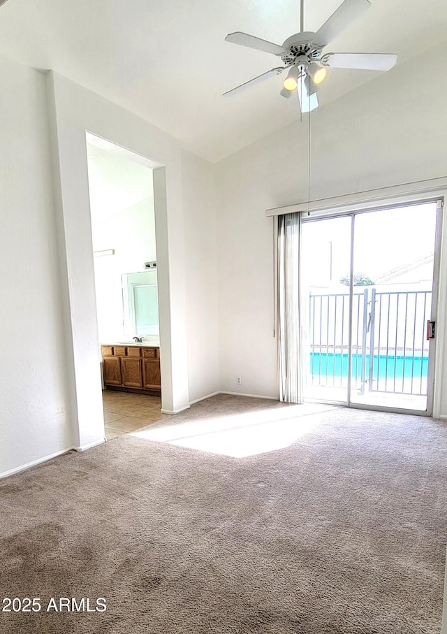 unfurnished room featuring ceiling fan, a sink, and light colored carpet