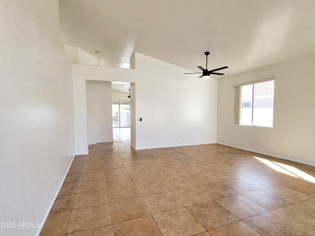 unfurnished room featuring light tile patterned floors, a ceiling fan, and baseboards