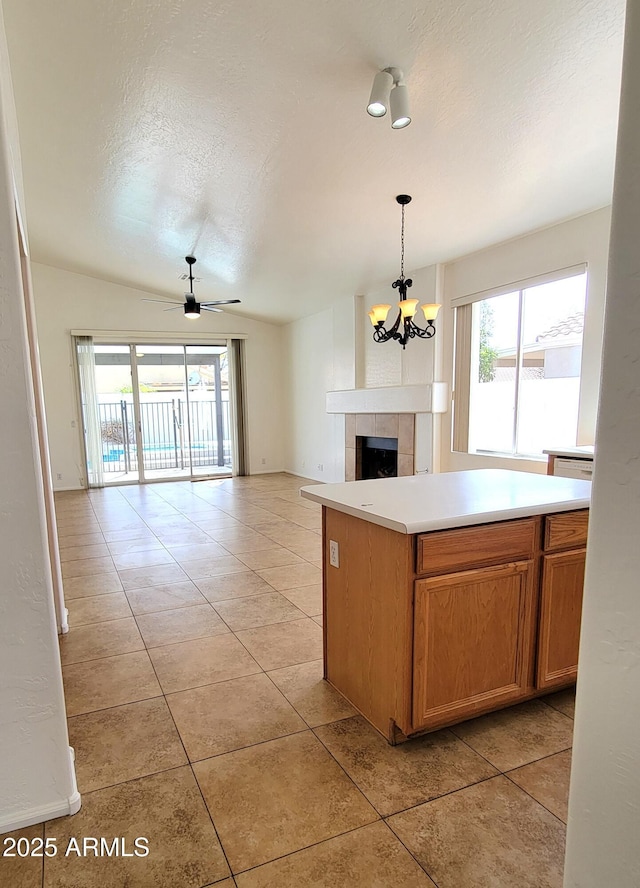 kitchen featuring open floor plan, light countertops, hanging light fixtures, and light tile patterned flooring