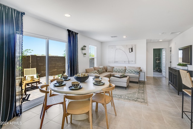 dining area with light tile patterned floors, visible vents, and recessed lighting