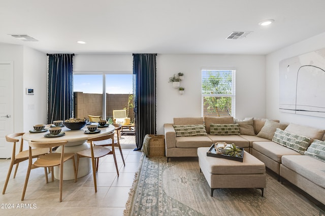 living area featuring recessed lighting, visible vents, and a healthy amount of sunlight