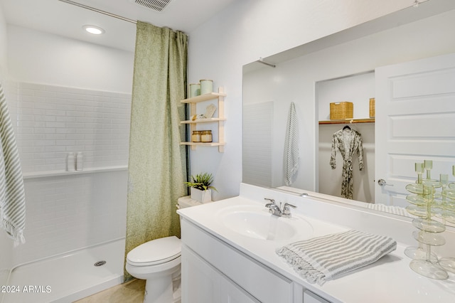 full bathroom featuring a shower stall, vanity, visible vents, and toilet