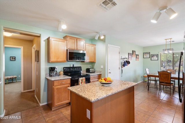 kitchen with light tile patterned flooring, hanging light fixtures, black range with electric cooktop, a kitchen island, and light stone countertops