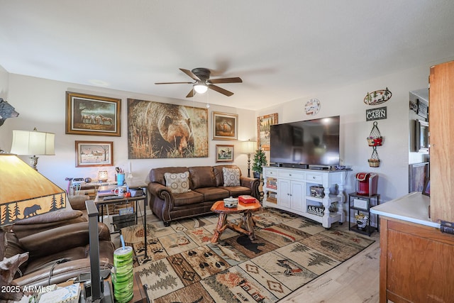 living room with ceiling fan and light hardwood / wood-style flooring